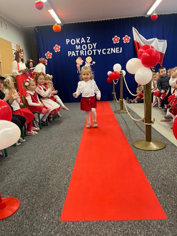 dziewczynka idzie na pokazie mody patriotycznej
