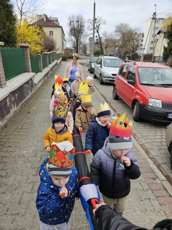 Dzieci spacerują i dmuchają w urodzinowe trąbki