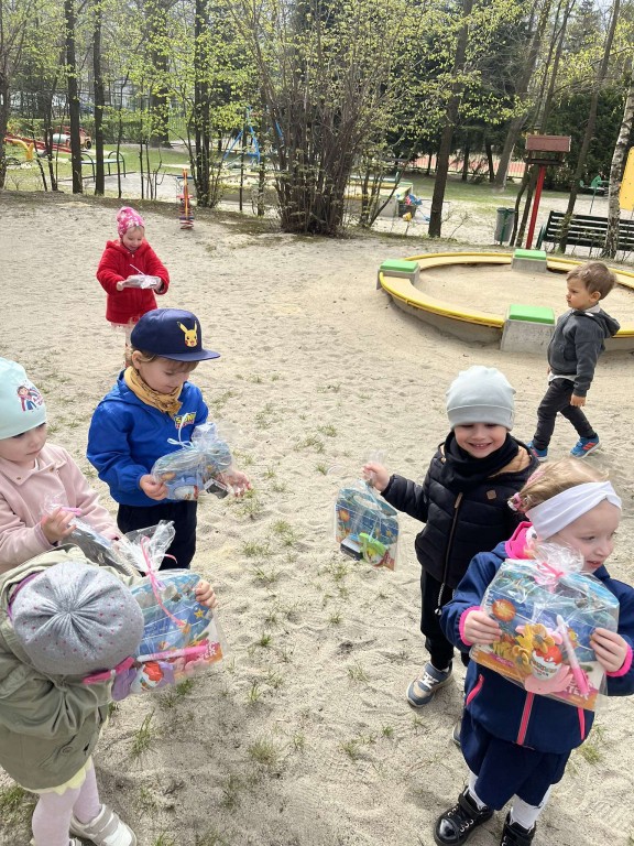 dziecko pozuje z prezentem do zdjęcia