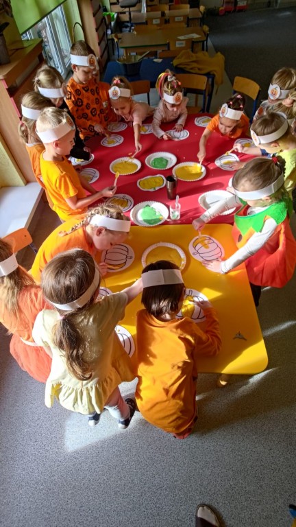 dzieci wykonuja prace plastyczna dynia