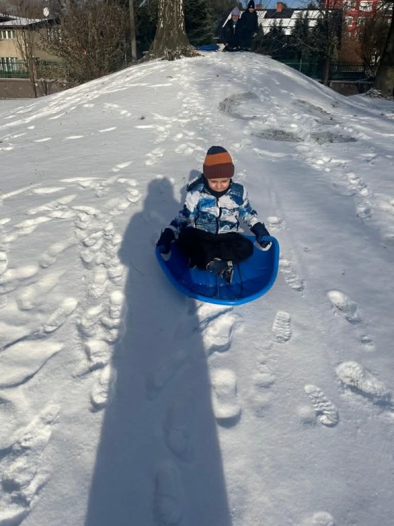 dzieci zjeżdżają z górki