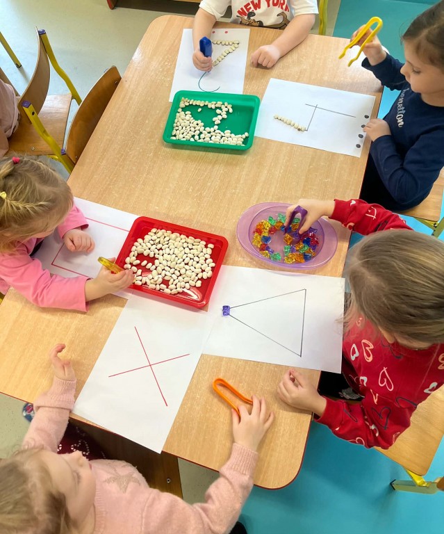 dzieci układają matematyczne kształty i cyfry materiałem sensorycznym