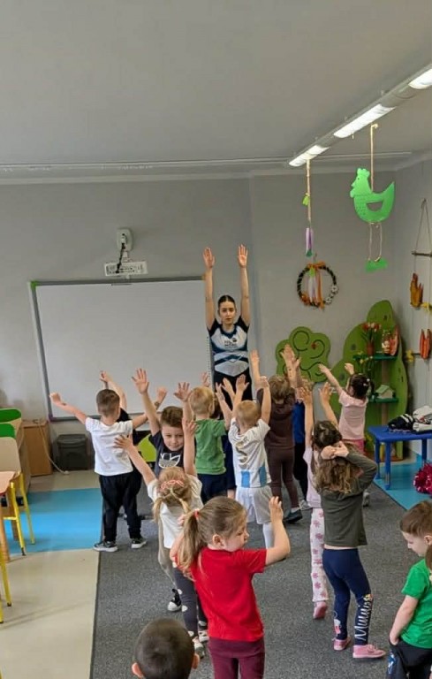 dzieci prostują ręce w górze